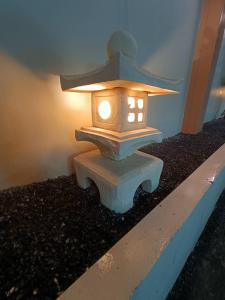 a lantern sitting on top of a stone bench at SK Village in Ban Baen Phichit