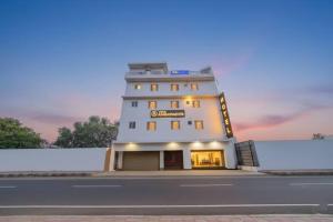 a building with a sign on the side of a road at HOTEL AMBASSADOR SUKHNA LaKE in Chandīgarh