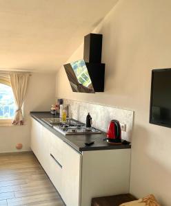 a kitchen with a stove and a counter top at Le Mongolfiere in Mondovì +14 photos