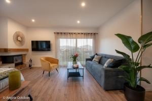 a living room with a couch and a table at L'Attrape-Rêves in La Gaude