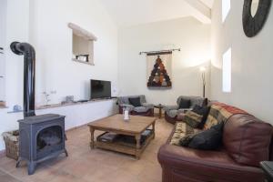 a living room with a couch and a wood stove at Villa Angel by Algarve Holidays in Loulé