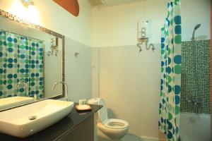 a bathroom with a sink and a toilet and a shower at Barn Talaepu Resort in Ban Suan Khat +20 photos