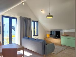 a living room with a blue couch and a table at Heiligenhafenbude 2 in Heiligenhafen