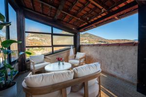 a room with a table and chairs on a balcony at L'Attrape-Rêves in La Gaude