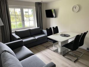 a living room with a couch and a table at Seaside-Amrum-6 in Norddorf