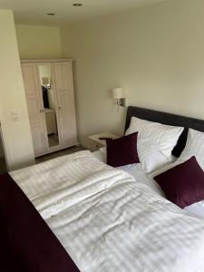 a bedroom with two beds and a mirror at Seaside-Amrum-6 in Norddorf