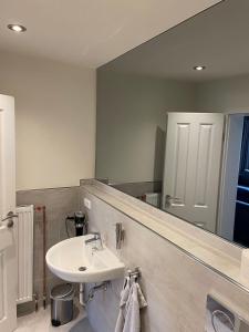 a bathroom with a sink and a mirror at Seaside-Amrum-6 in Norddorf +1 photo