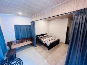 a bedroom with a bed and a couch in it at Hill valley farm resort in Munnar