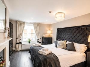 a bedroom with a large bed with two towels on it at Hexham Town Centre, Market Place View in Hexham