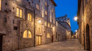 an alley in an old town at night at Roberto Historic House in Gubbio