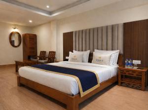 a bedroom with a large bed and two tables at Teesta Hotels, Kalimpong in Kalimpong +22 photos