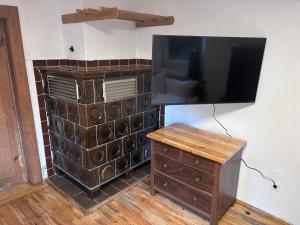 a entertainment center with a flat screen tv and a wooden dresser at Haus Abendsonne in Bad Schandau