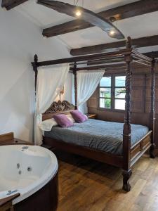 a bedroom with a bed and a bath tub at Las Casas de Isu in Villaviciosa