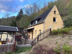 a large yellow building with a black roof at Haus Abendsonne in Bad Schandau