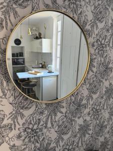 a kitchen with a large mirror on a wall at La Loge 45 in Rodez