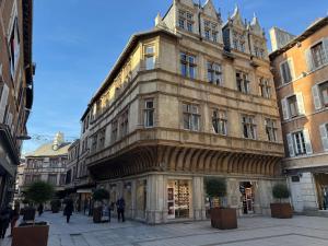 a large building on a street in a city at La Loge 45 in Rodez