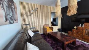 a living room with a couch and a coffee table at Maison canal - Douceur Occitane in Moissac