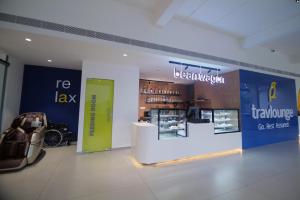 a store with a sign for a bar in a building at Travlounge Adimali in Chillithodu