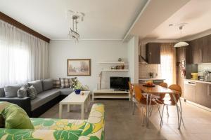 a living room with a couch and a table at Olympus & Sea Harmony in Katerini