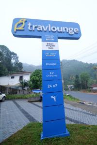 a sign for a turquoiseurance gas station at Travlounge Adimali in Chillithodu