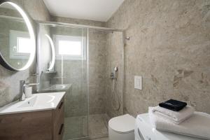 a bathroom with a shower and a toilet and a sink at Olympus & Sea Harmony in Katerini +40 photos