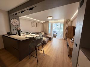 a kitchen and living room with a table and chairs at Sunny Waves Apartment in Cullera
