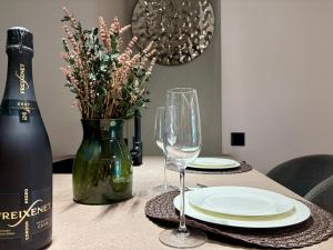 a table with two glasses and a bottle of wine at Sunny Waves Apartment in Cullera
