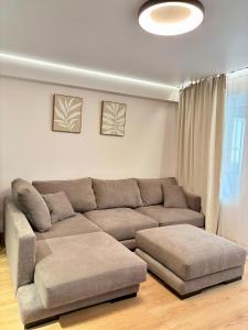 a living room with a couch and a ottoman at Sunny Waves Apartment in Cullera