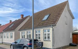 a house with a car parked in front of it at 3 Bedroom Gorgeous Home In Faaborg in Faaborg