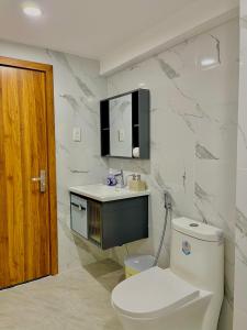 a white bathroom with a toilet and a sink at Son Tra homestay in Danang +57 photos