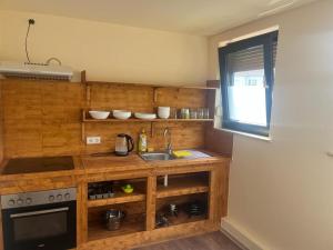 a kitchen with a sink and a stove at Pension Highway - Bielefeld Senner Hellweg 227 in Bielefeld +8 photos