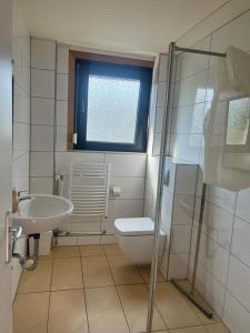 a bathroom with a toilet and a sink and a shower at Pension Highway - Bielefeld Senner Hellweg 227 in Bielefeld