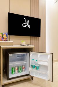a refrigerator with its door open in a room at Holiday Homez, City Centre with Free Airport & Train Station Pickup in New Delhi
