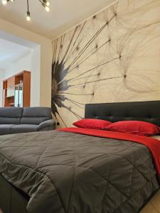 a bedroom with a large bed and a wall at Viale Umberto Apartments in Sassari