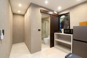 a small bathroom with a toilet and a sink at OHASIS by OH Hotels in Bangkok +74 photos