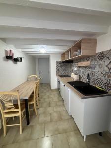 a kitchen with a wooden table and a dining room at Toue de Loire in Chaumont-sur-Loire