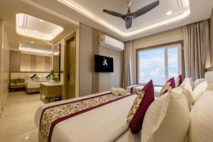 a bedroom with a bed with a ceiling fan at Holiday Homez, City Centre with Free Airport & Train Station Pickup in New Delhi +57 photos
