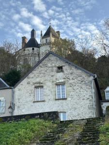 an old stone building with a tower on top of it at Toue de Loire in Chaumont-sur-Loire
