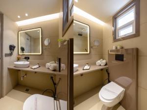 a bathroom with two sinks and a toilet at Holiday Homez, City Centre with Free Airport & Train Station Pickup in New Delhi