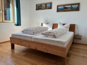 a bed with two pillows on it in a room at a feines Platzl in Asch