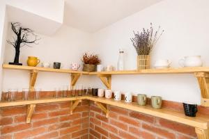 a room with wooden shelves on a brick wall at Héthajnal Apartman in Debrecen