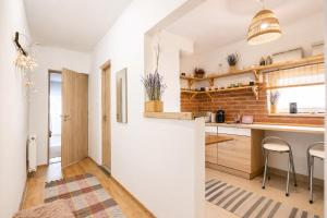 a kitchen with white walls and wooden countertops at Héthajnal Apartman in Debrecen