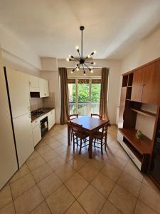 a kitchen with a table and chairs and a dining room at Viale Umberto Apartments in Sassari