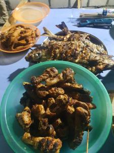 a plate of food on a table with food at Luk inn at huraa in Huraa
