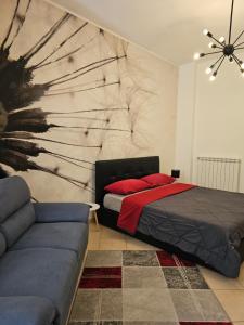 a bedroom with a bed and a couch at Viale Umberto Apartments in Sassari +8 photos