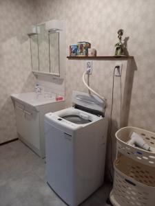 a small bathroom with a toilet and a sink at ミエル富士 in Oishi +9 photos