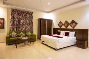 a hotel room with a bed and a couch at Golden New Hira Serviced Apartments in Jeddah +45 photos