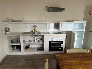 a small kitchen with a sink and a stove at Pension Highway - Bünde Carl Diem Straße 46 in Bünde