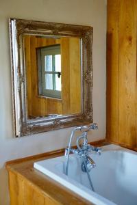 a bathroom with a sink and a mirror at Mas De Garrigue - Chambres d'hôtes in Calvignac