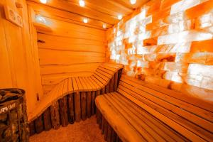 a wooden bench in a sauna with a brick wall at Complex Starite Kashti in Razvalini Balchikioy +183 photos